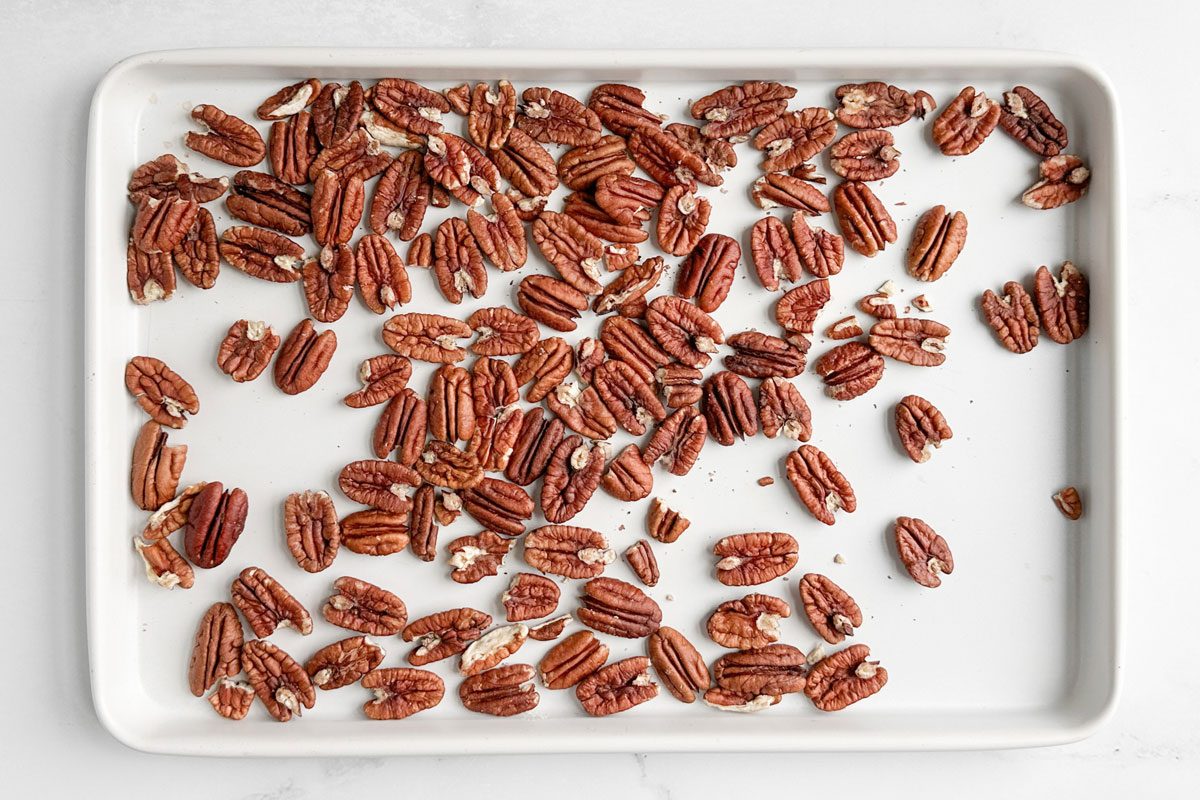 Pecans for Taste of Home Candied Pecans on a white baking sheet