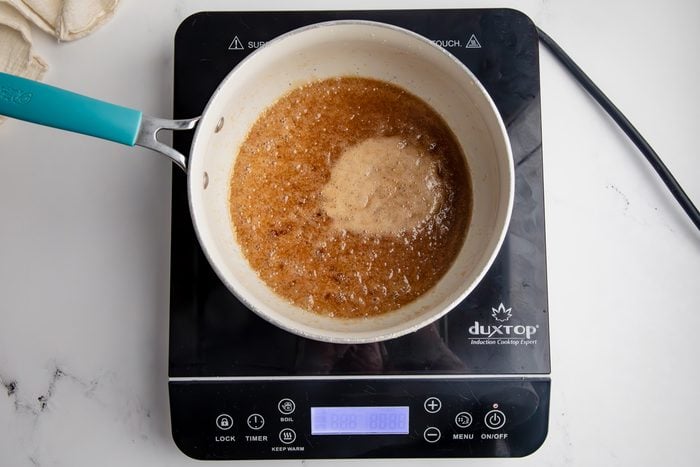 Overhead shot for Taste of Home Caramel Chex Mix, making homemade caramel over an induction cooktop.