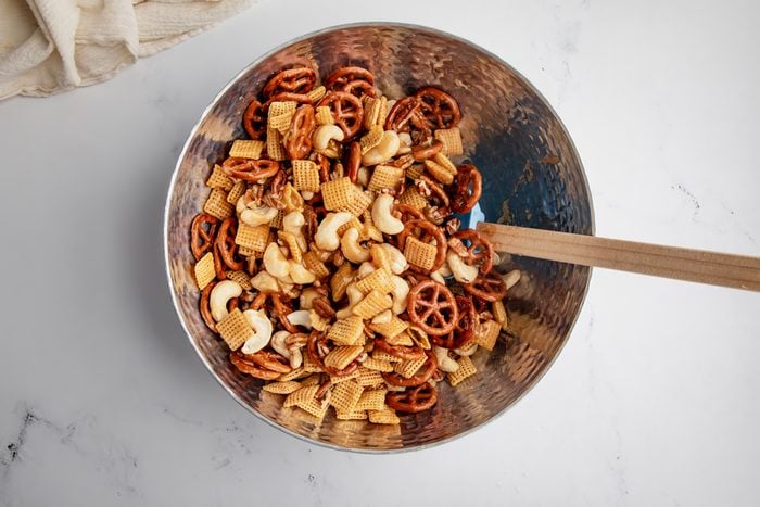 Overhead shot for Taste of Home Caramel Chex Mix, mixing the caramel sauce with the dry ingredients.