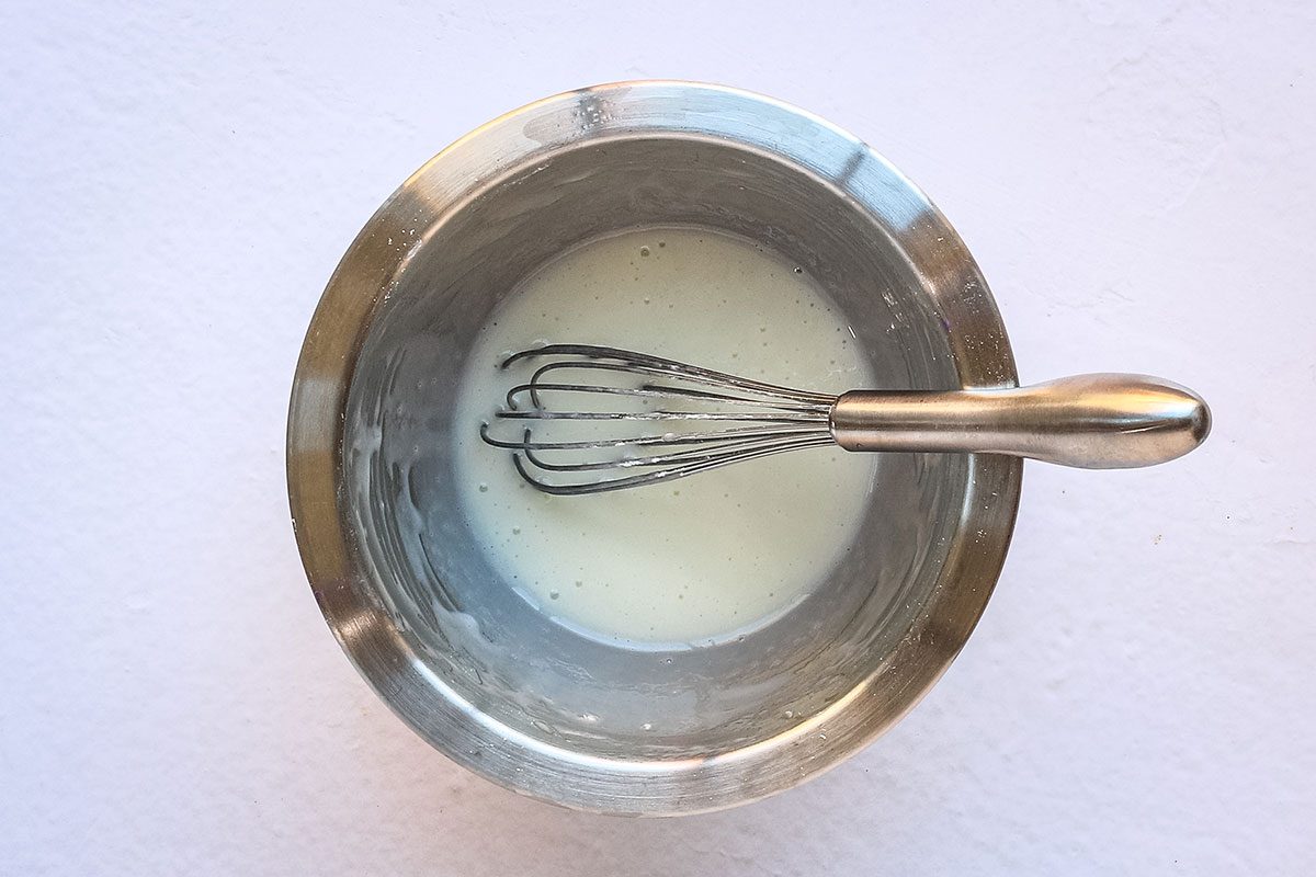 The sour cream topping for a layered carrot cake cheesecake.