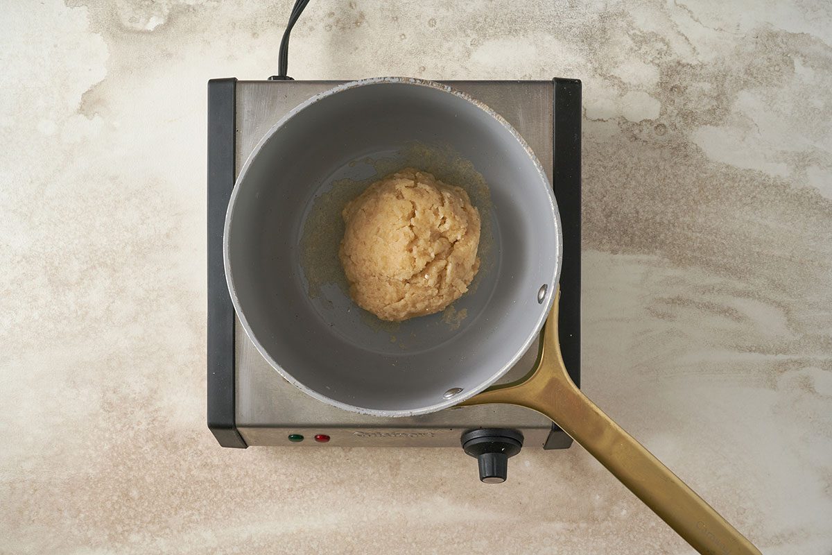 Boiling water, butter, salt, and cayenne, then stirring in flour to form a smooth dough for the Cheese Puffs recipe, by Taste of Home. Beating in eggs and stirring in Gruyere cheese and mustard.