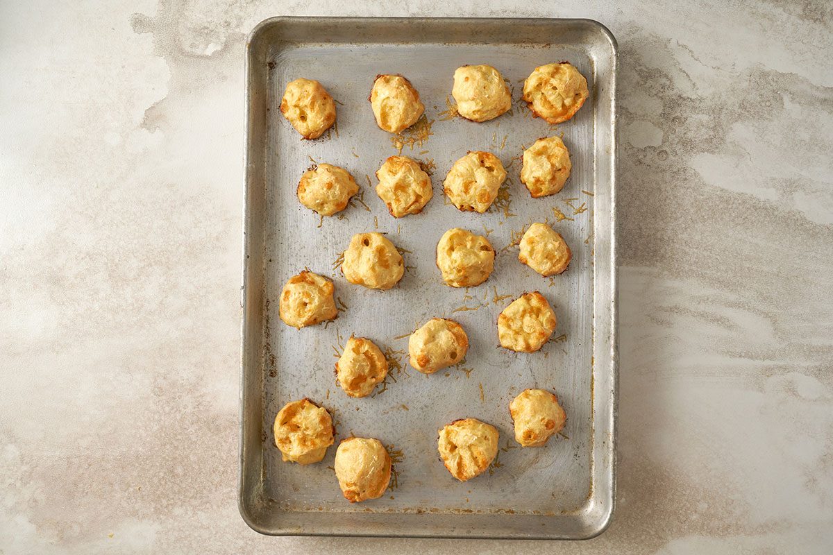 Baking the cheese balls until golden brown, served warm or cold, for the Cheese Puffs recipe, by Taste of Home.