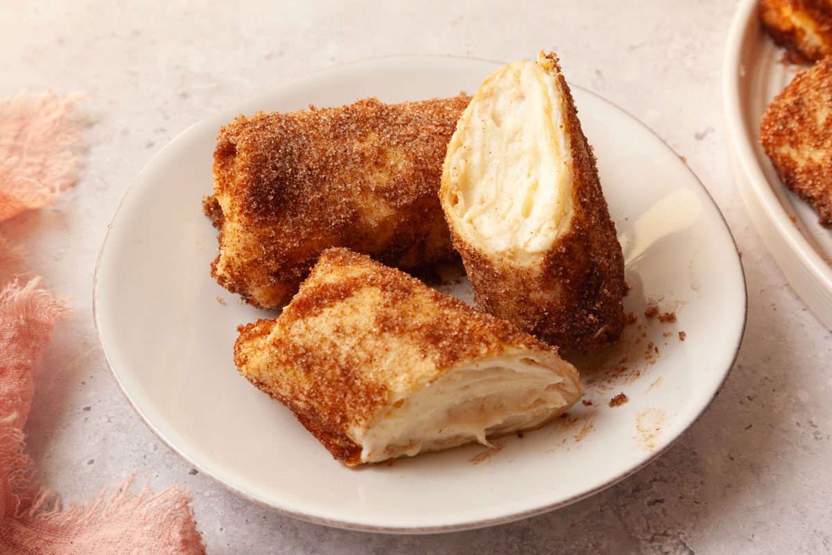 Two Taste of Home Cheesecake Chimichangas on a small plate