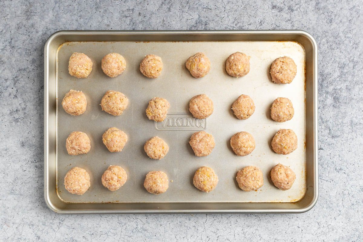 prepped meatballs on a baking sheet