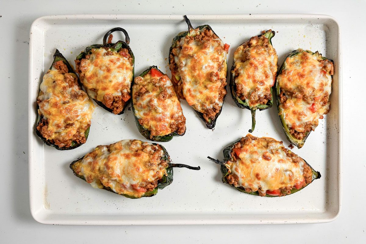 Taste of Home Chili Stuffed Poblano Peppers on a white baking sheet