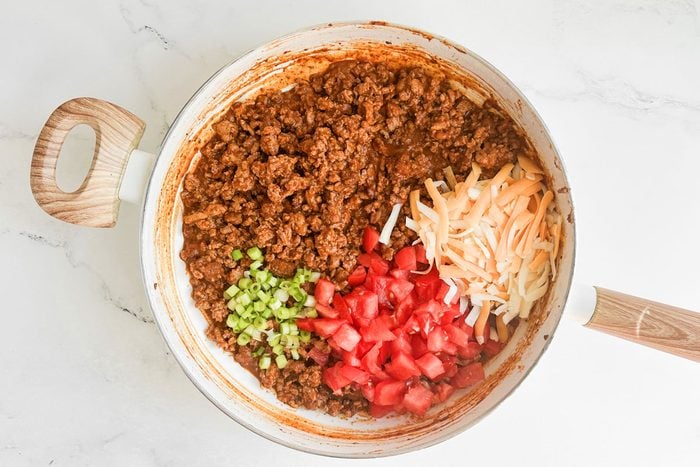 Filling for Taste of Home Chili Stuffed Poblano Peppers in a white skillet