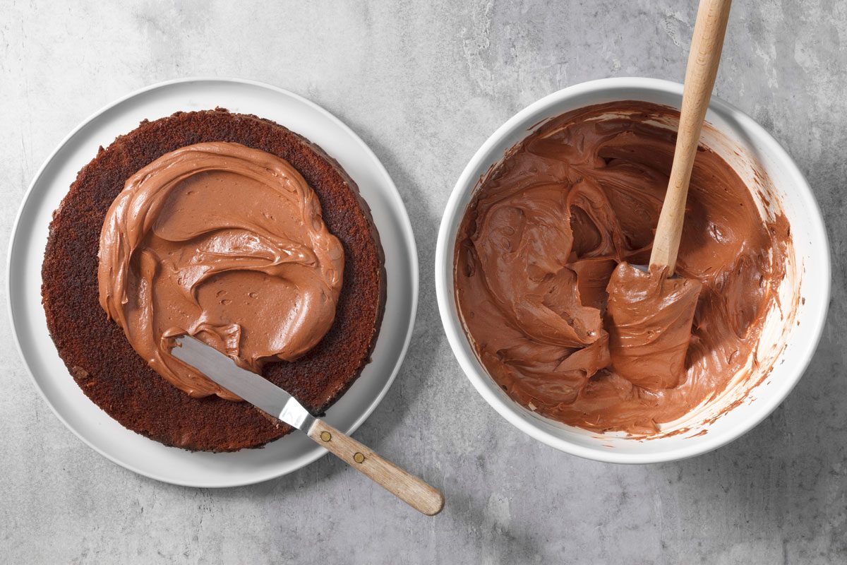 Applying frosting to a layer of the cake