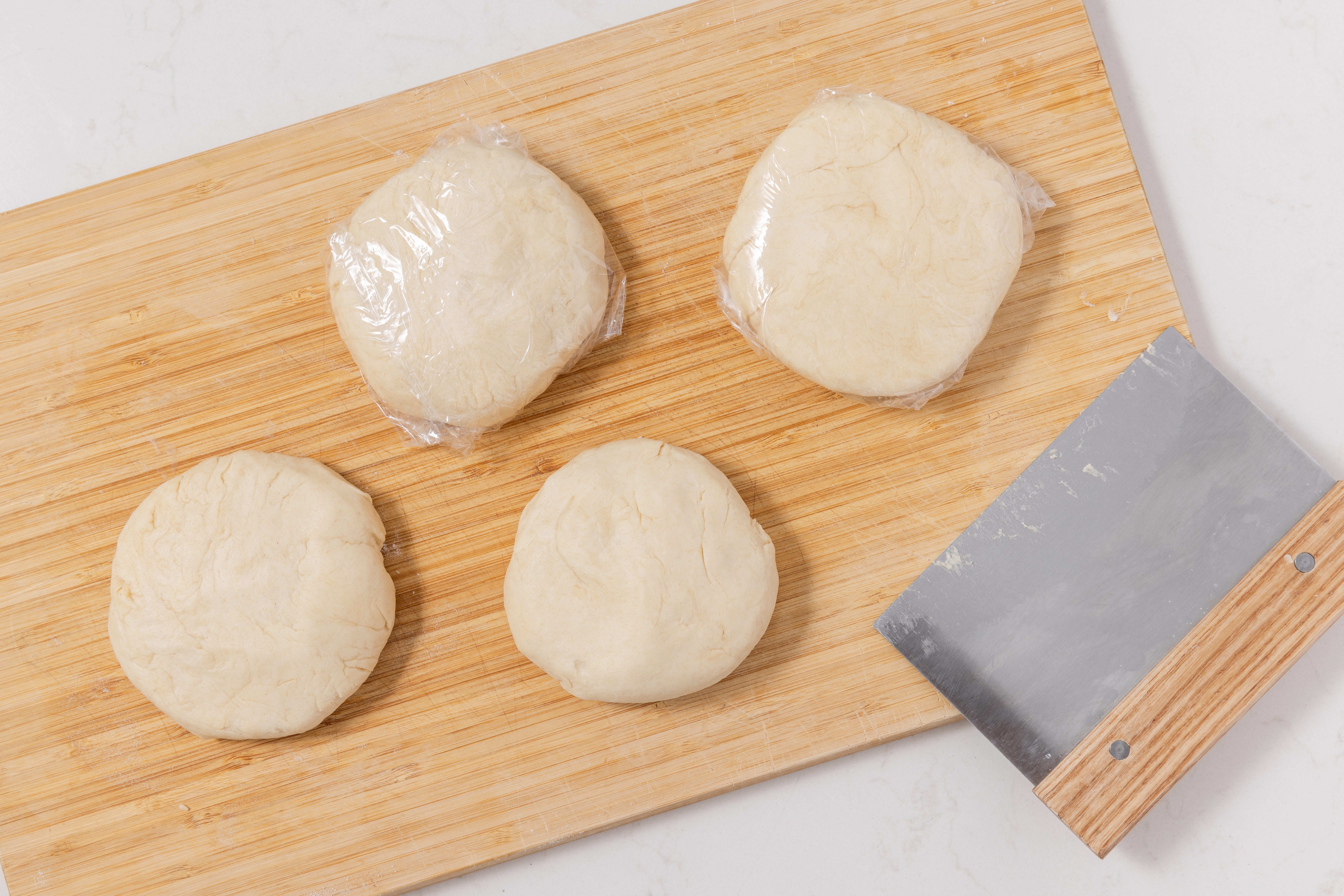 Dough for chocolate rugelach divided and wrapped into four disks to go in the fridge.