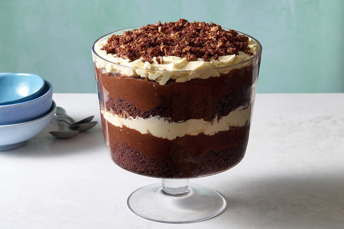 Straight-on shot of the chocolate trifle in a decorative glass serving bowl
