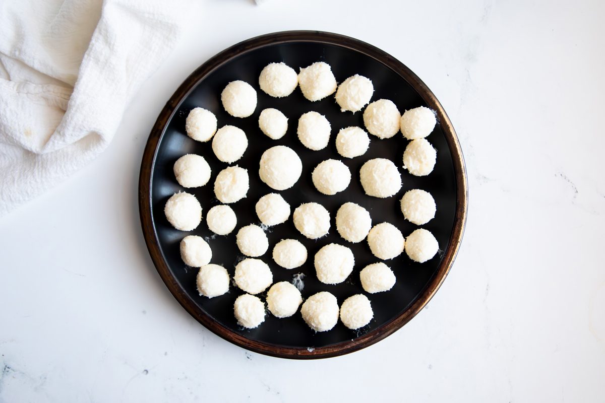 Overhead shot for Taste of Home Coconut Snowballs, coconut balls formed on a plate.