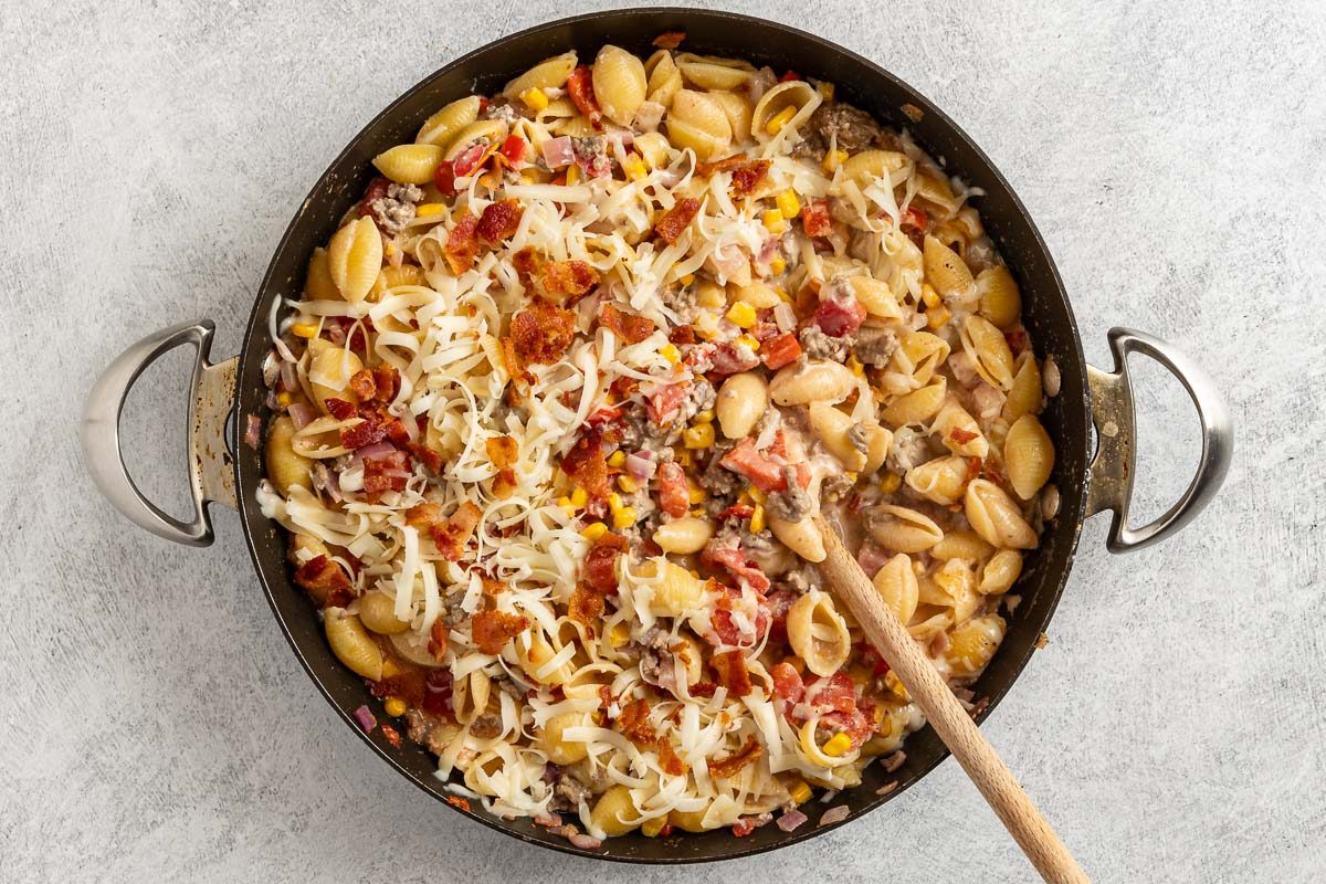 Taste of Home Cowboy Pasta photo of the pasta topped with Monterey Jack cheese and bacon.