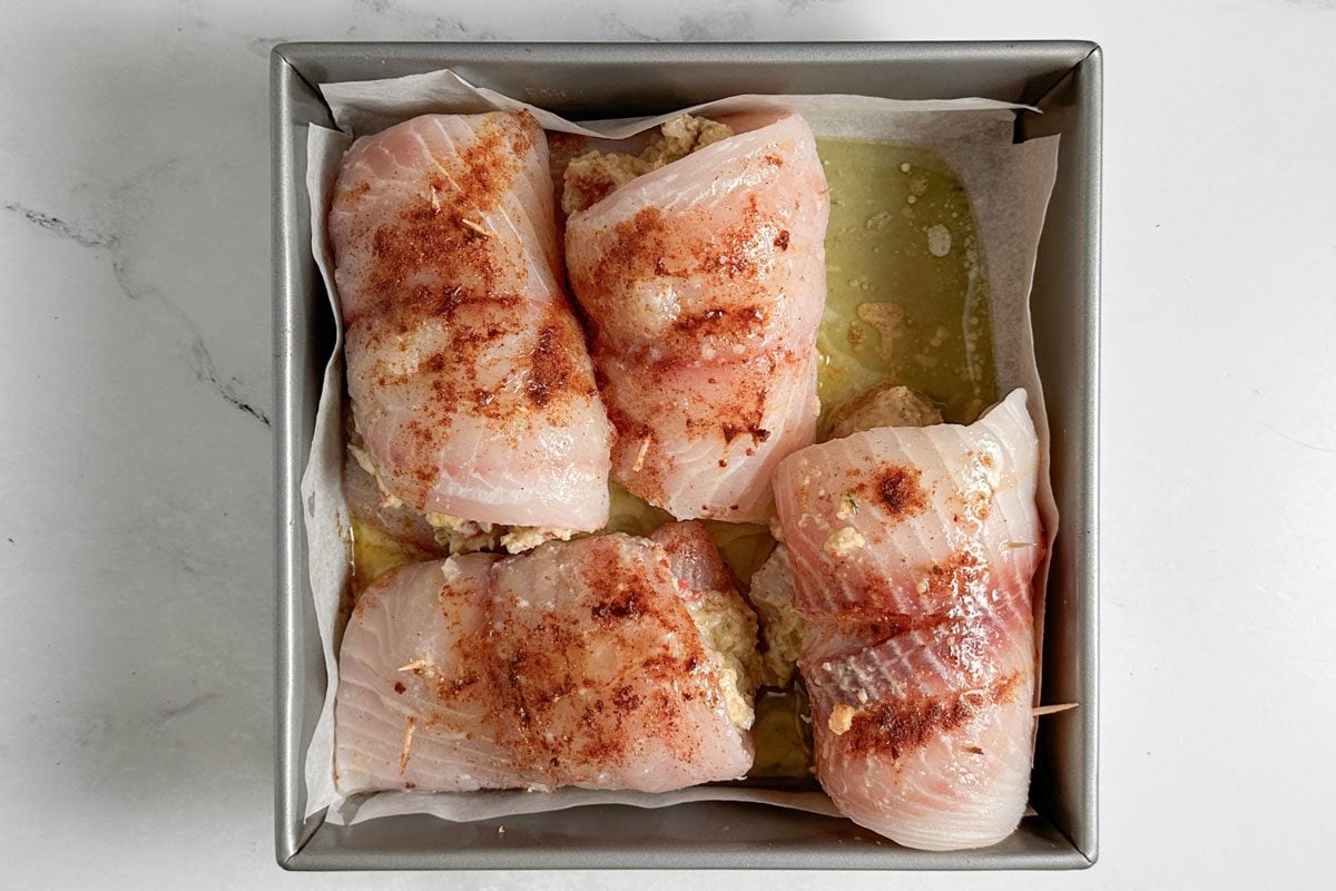 Unbaked Taste of Home Crab Stuffed Tilapia in a square baking pan