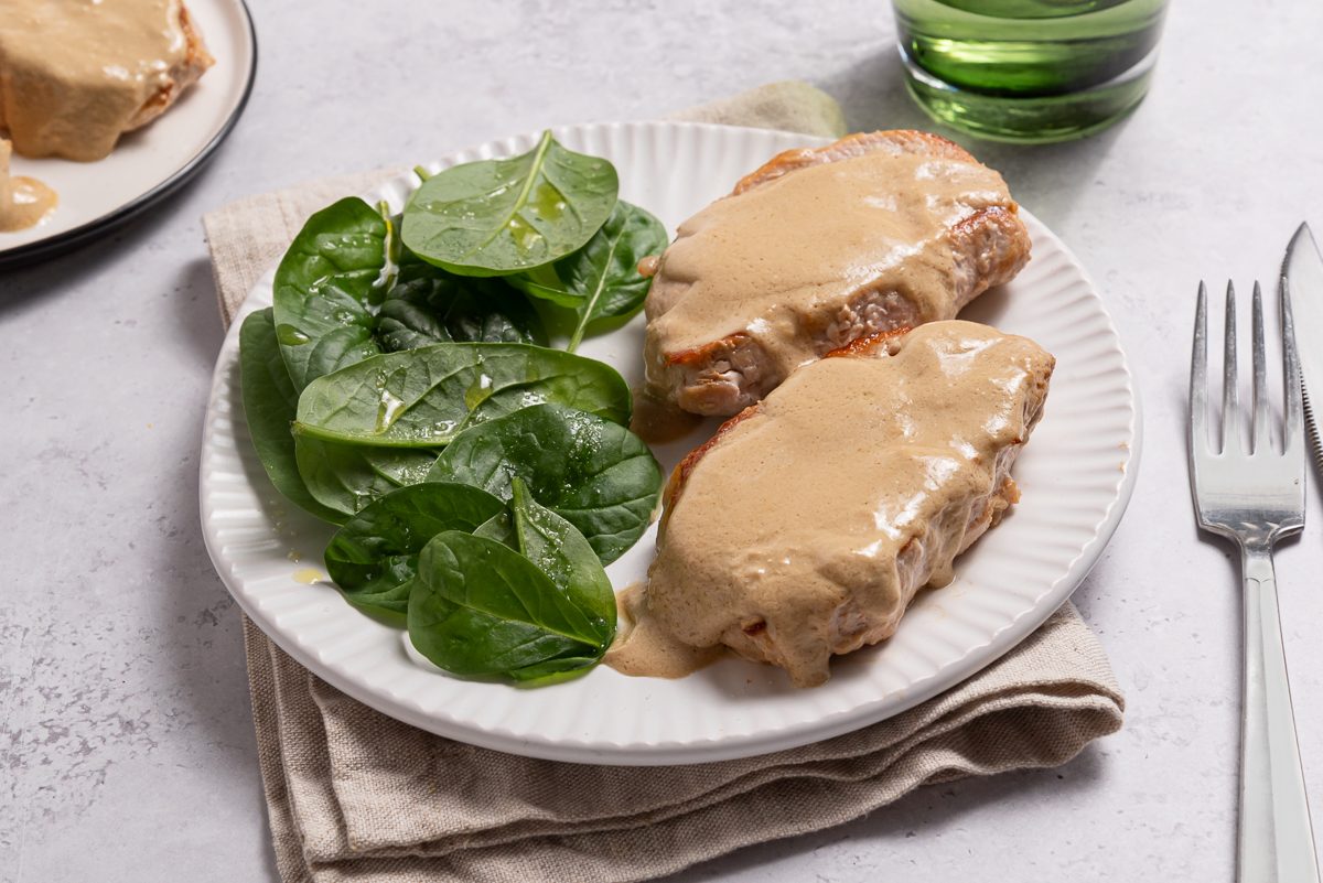 Plate With Cream Cheese Pork Tenderloin Chops And Green Salad
