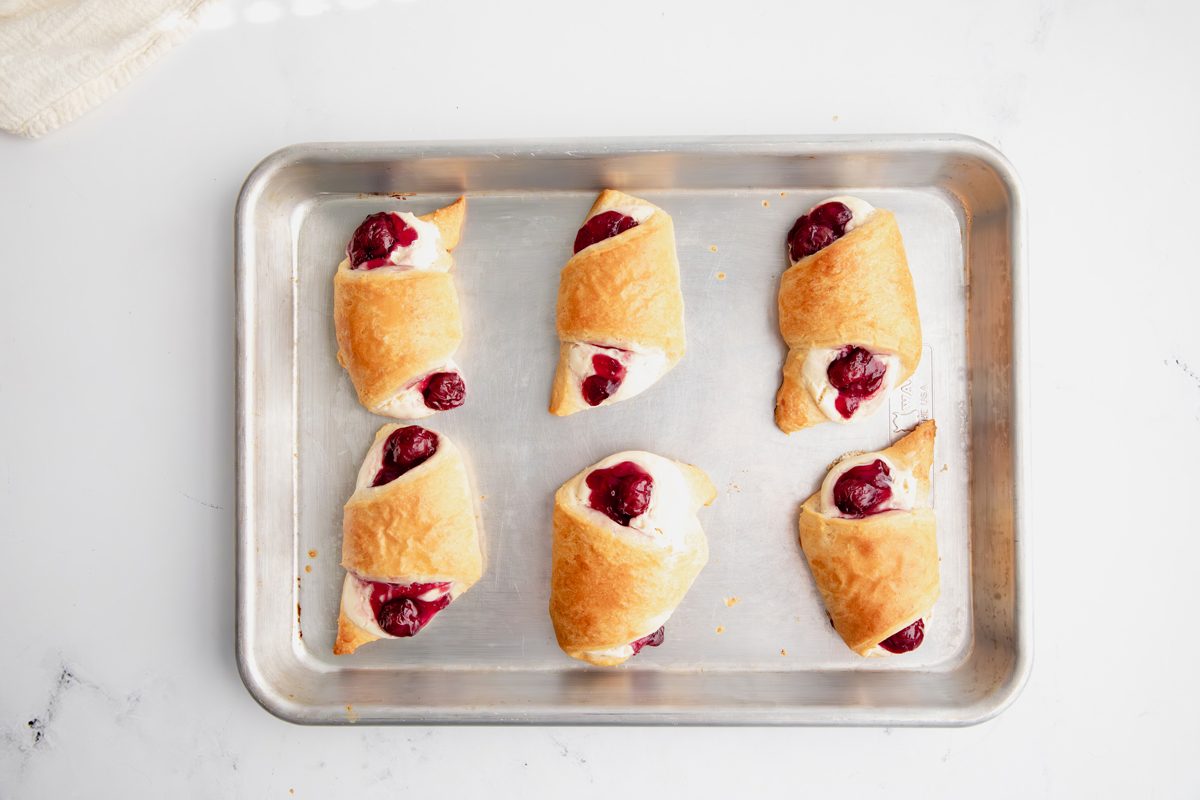 Overhead shot for Taste of Crescent Rolls with Cherry Pie Filling, baked crescent rolls with cream cheese and cherry filling inside.