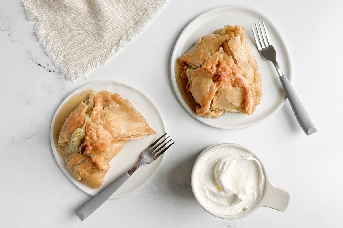 Taste of Home Easy Apple Dumplings on white plates with whipped cream