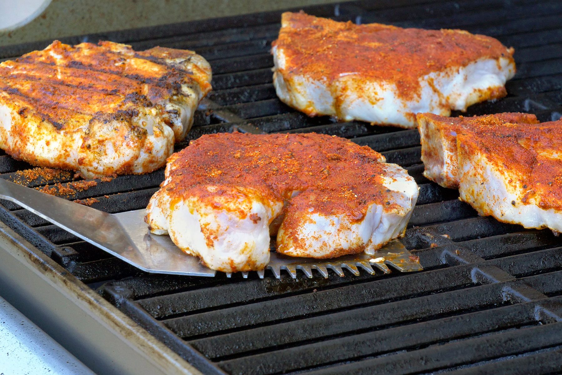 Pork chops being grilled.