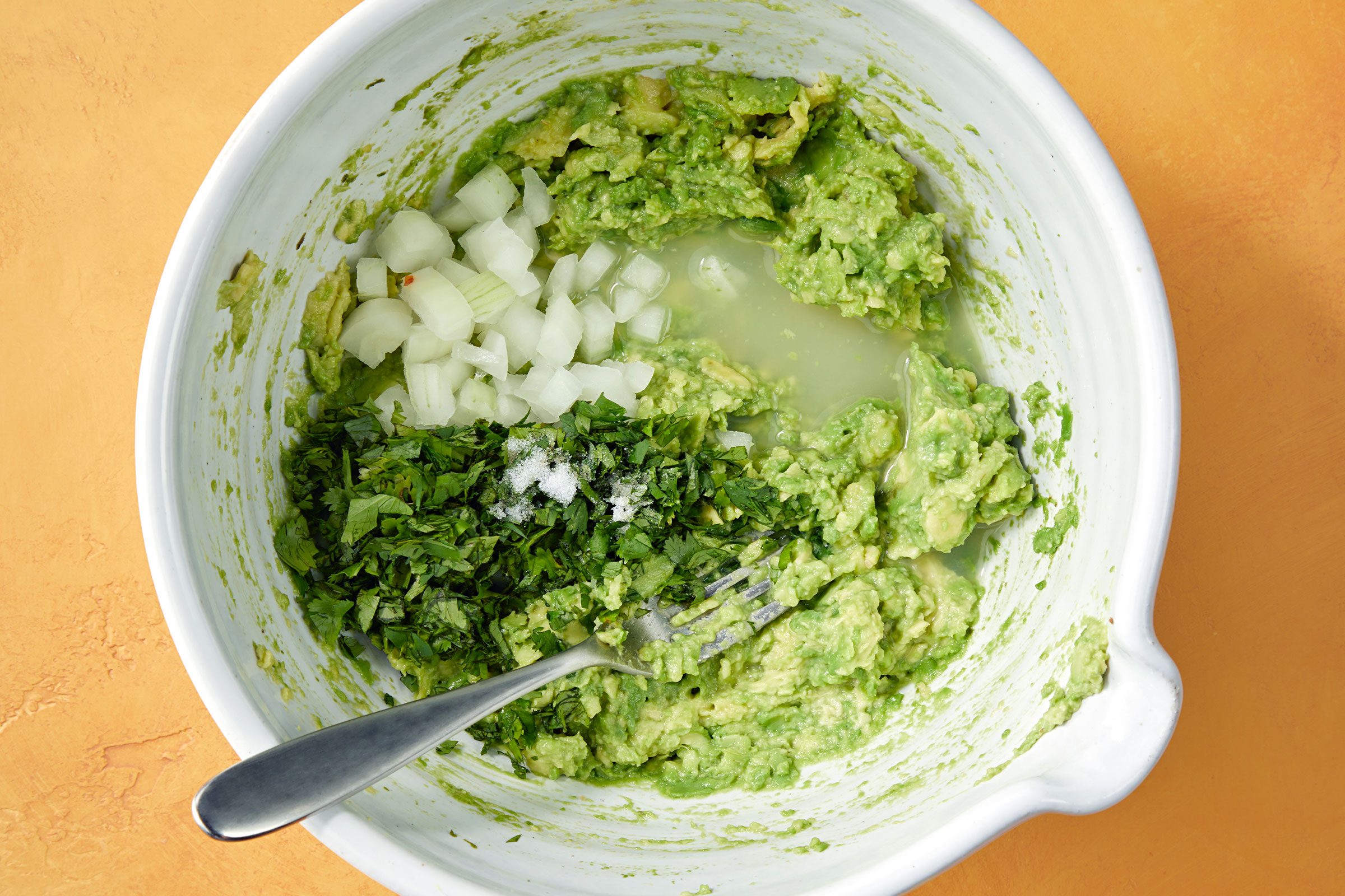 Mashed avocados with onion, cilantro, lime juice and salt.