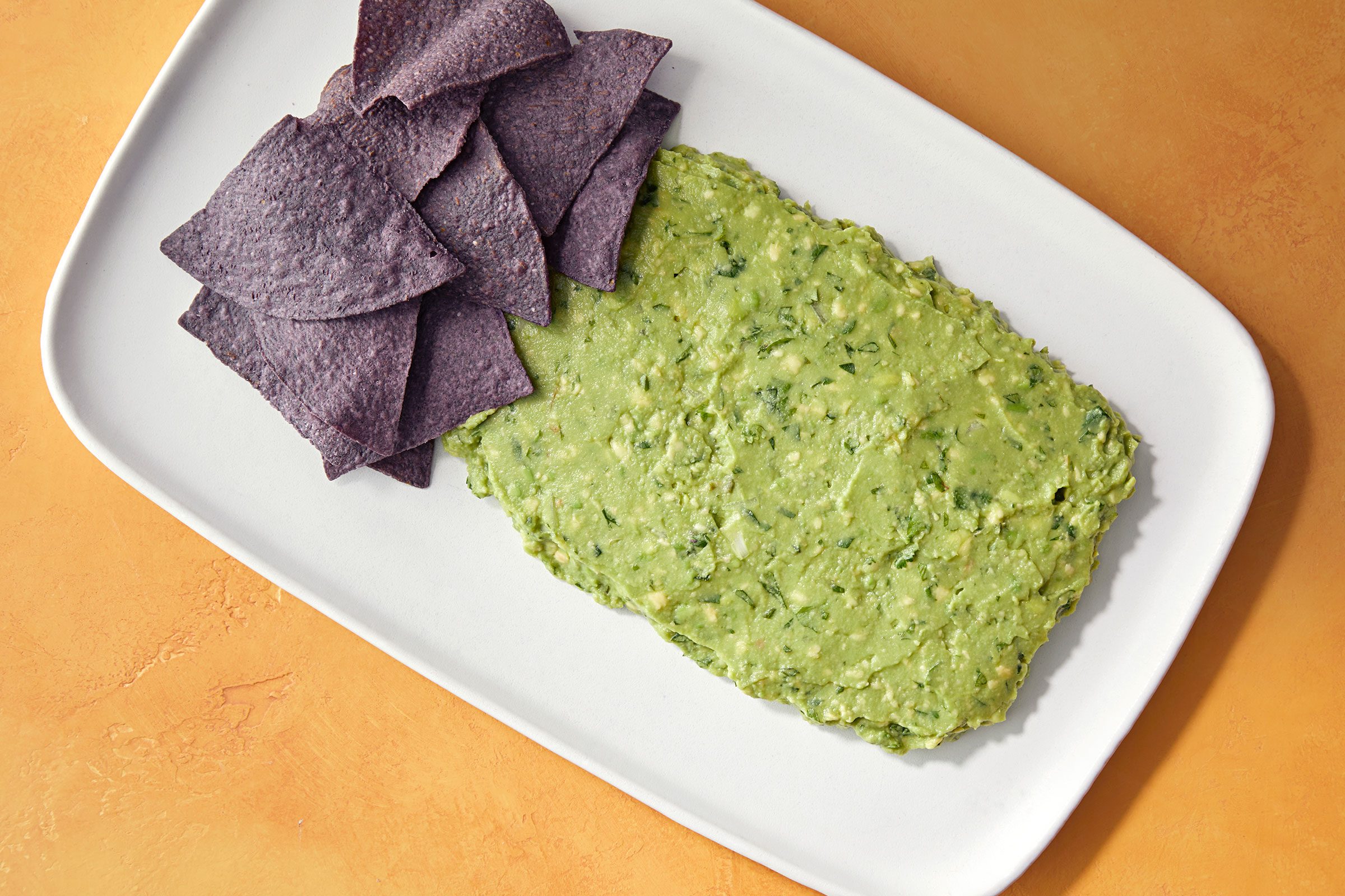 Guacamole shaped into a rectangle with chips on top