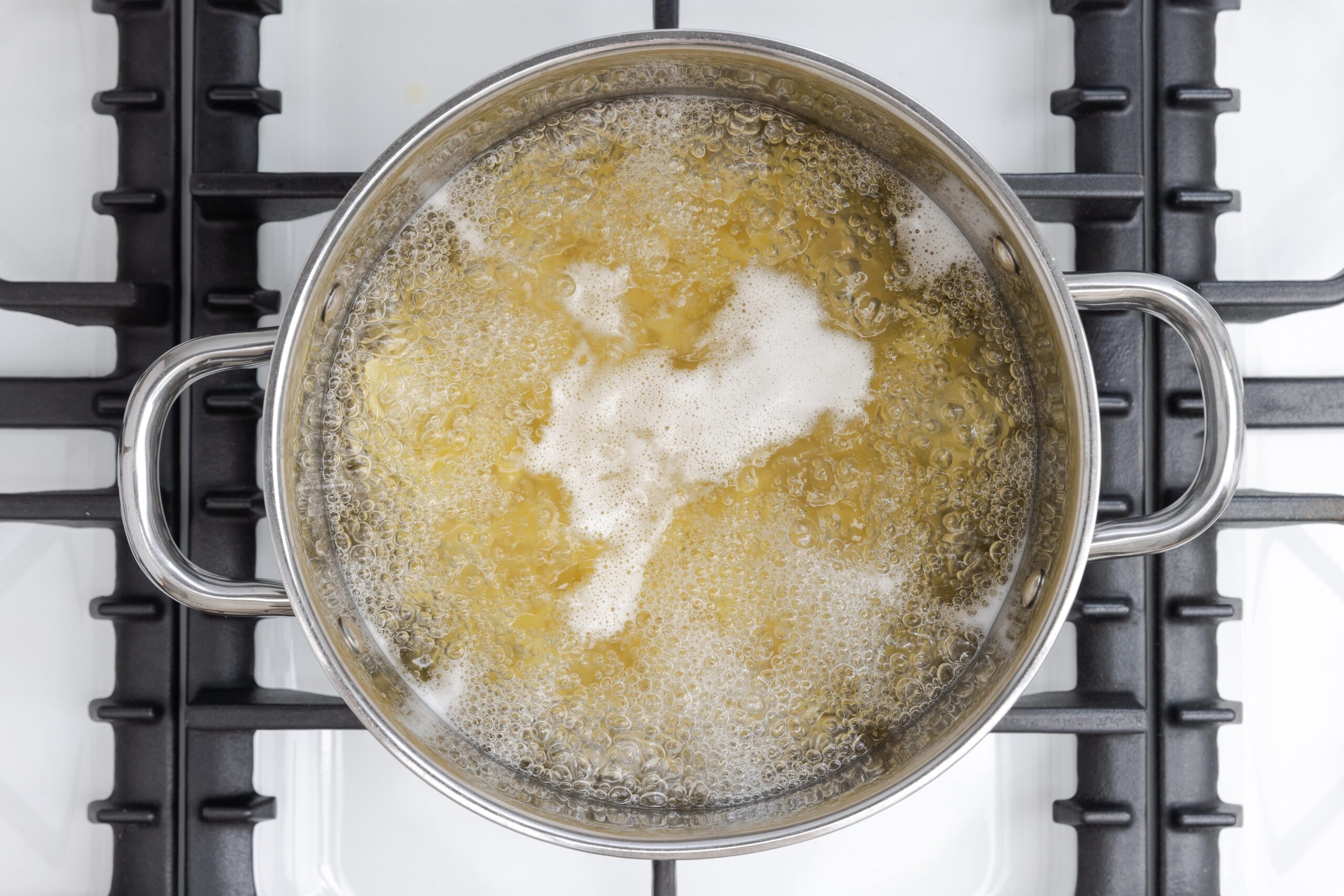 Egg noodles cooking in boiling water.