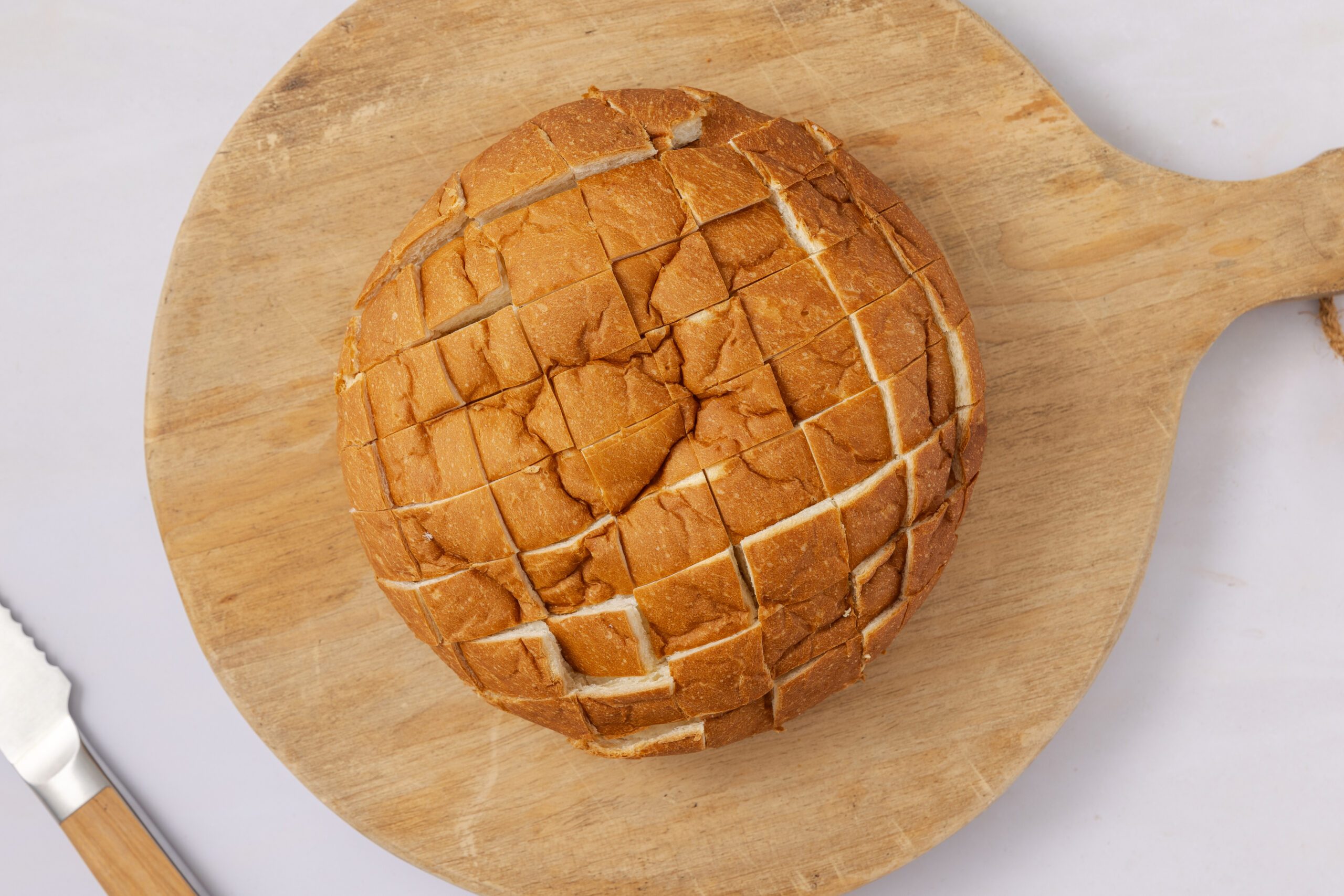 Hawaiian sweet bread being prepared cut into squares.