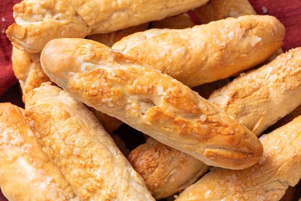 Homemade Breadsticks On A Wooden Platter For Taste Of Home
