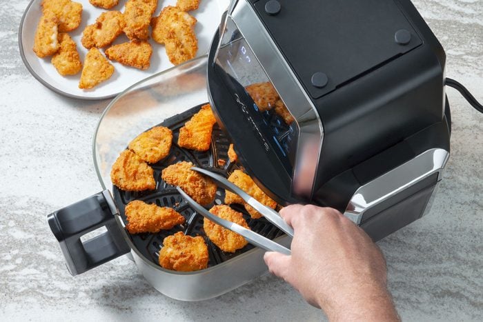 Chicken nuggets are being air fried.