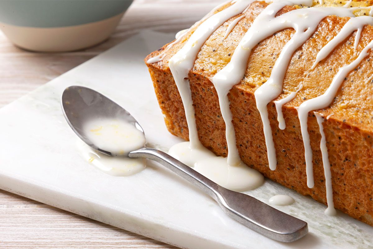 Lemon Glaze Poured Over Bread close up on spoon and glaze