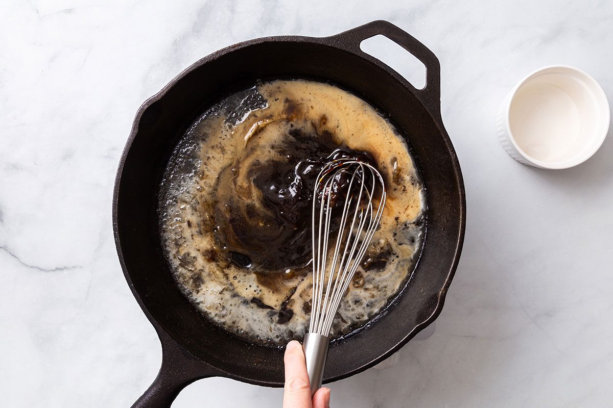 Cornstarch mixture being added to the maple syrup mixture for step four of Maple-Glazed Pork Chop recipe for Taste of Home