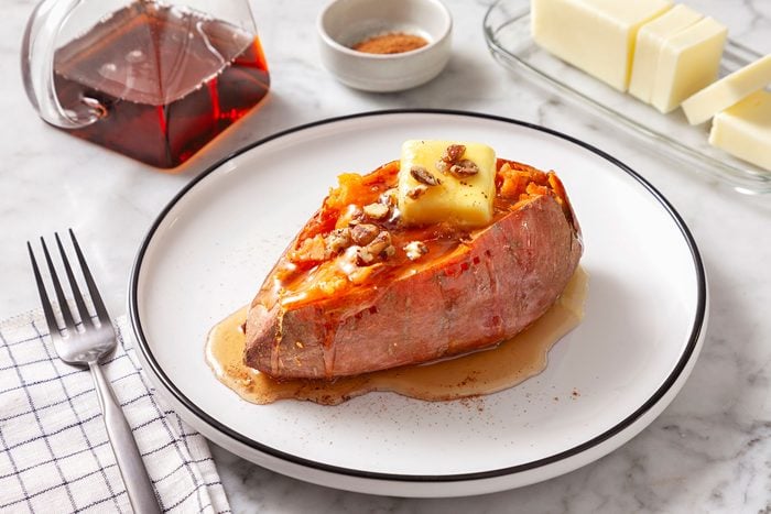 Microwave Sweet Potato served with pecan, ground cinnamon and maple syrup