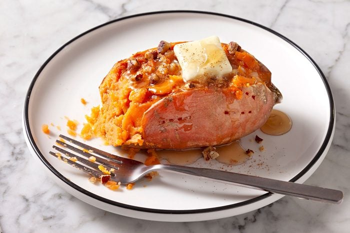 Microwave Sweet Potato served with pecan, ground cinnamon and maple syrup