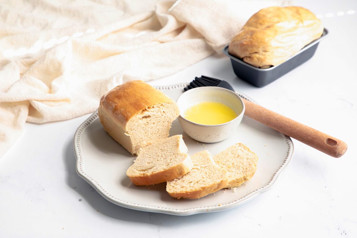 Beauty shot for Taste of Home Mini Bread Loaf, baked bread with melted butter on a plate.