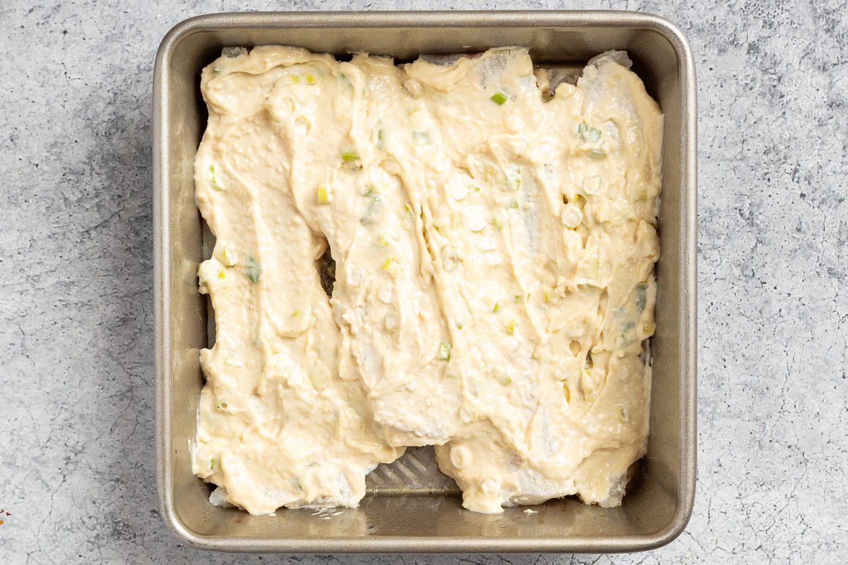 Taste of Home Parmesan Baked Cod photo of the sauce spooned over the cod.