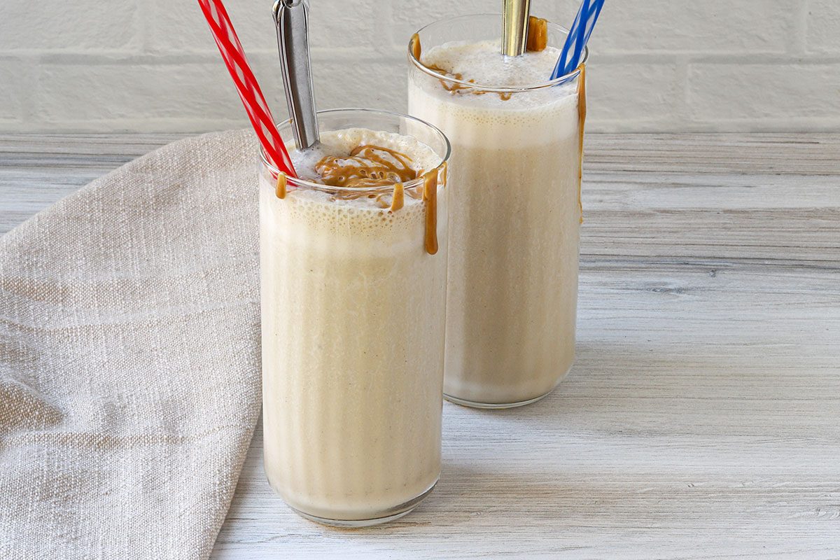 Peanut butter and banana smoothies with peanut butter drizzle.
