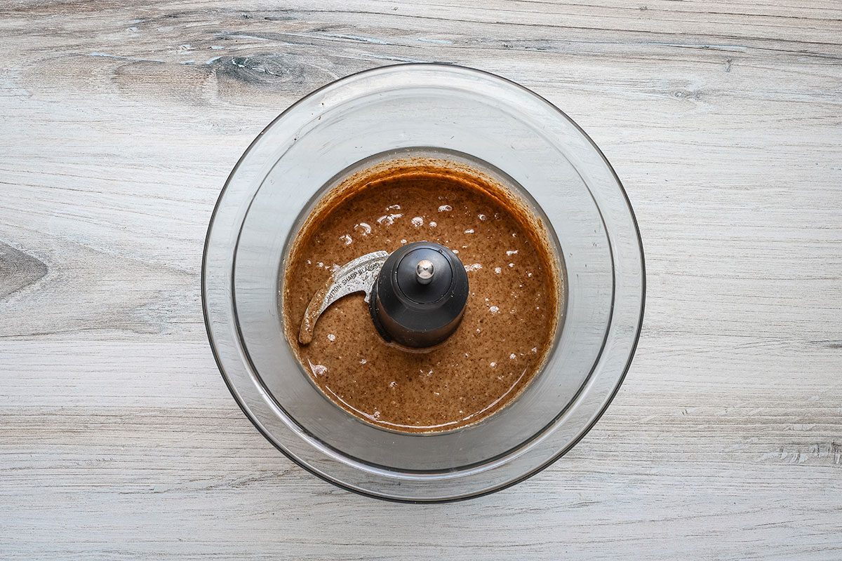 Pecan butter in a food processor bowl.