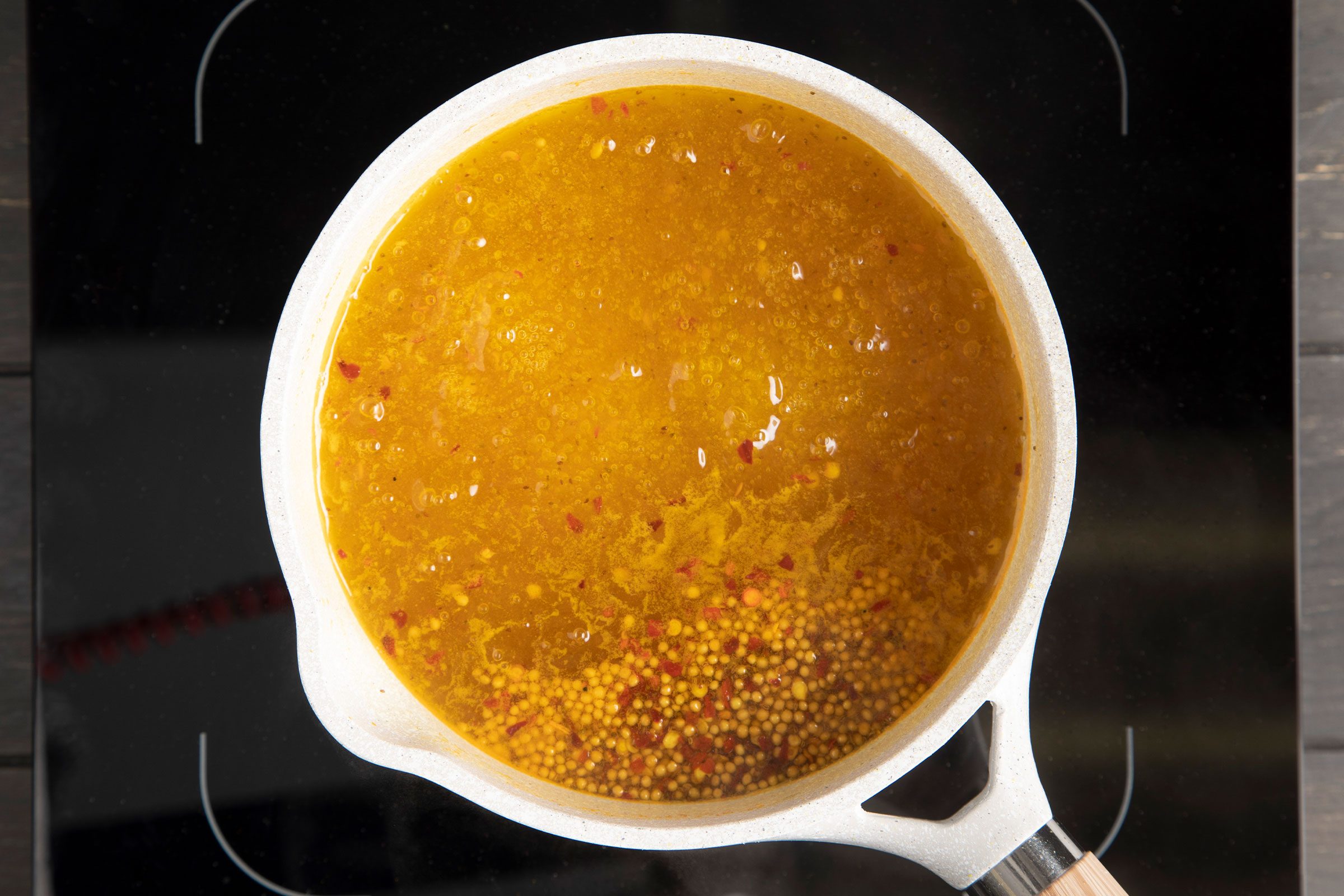 boiling brine for pickled cauliflower in a pot on a stovetop