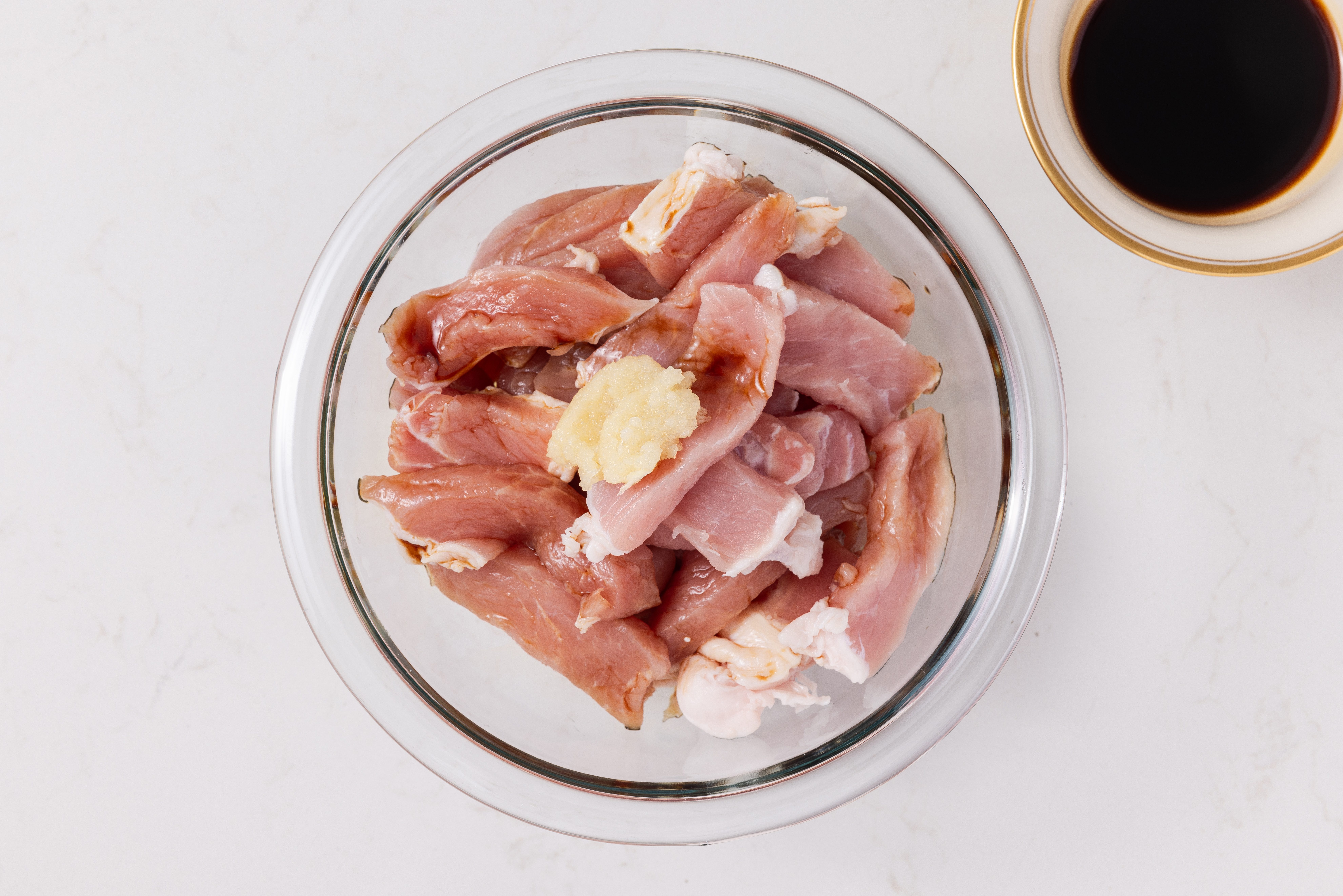 Small bowl with pork marinating.