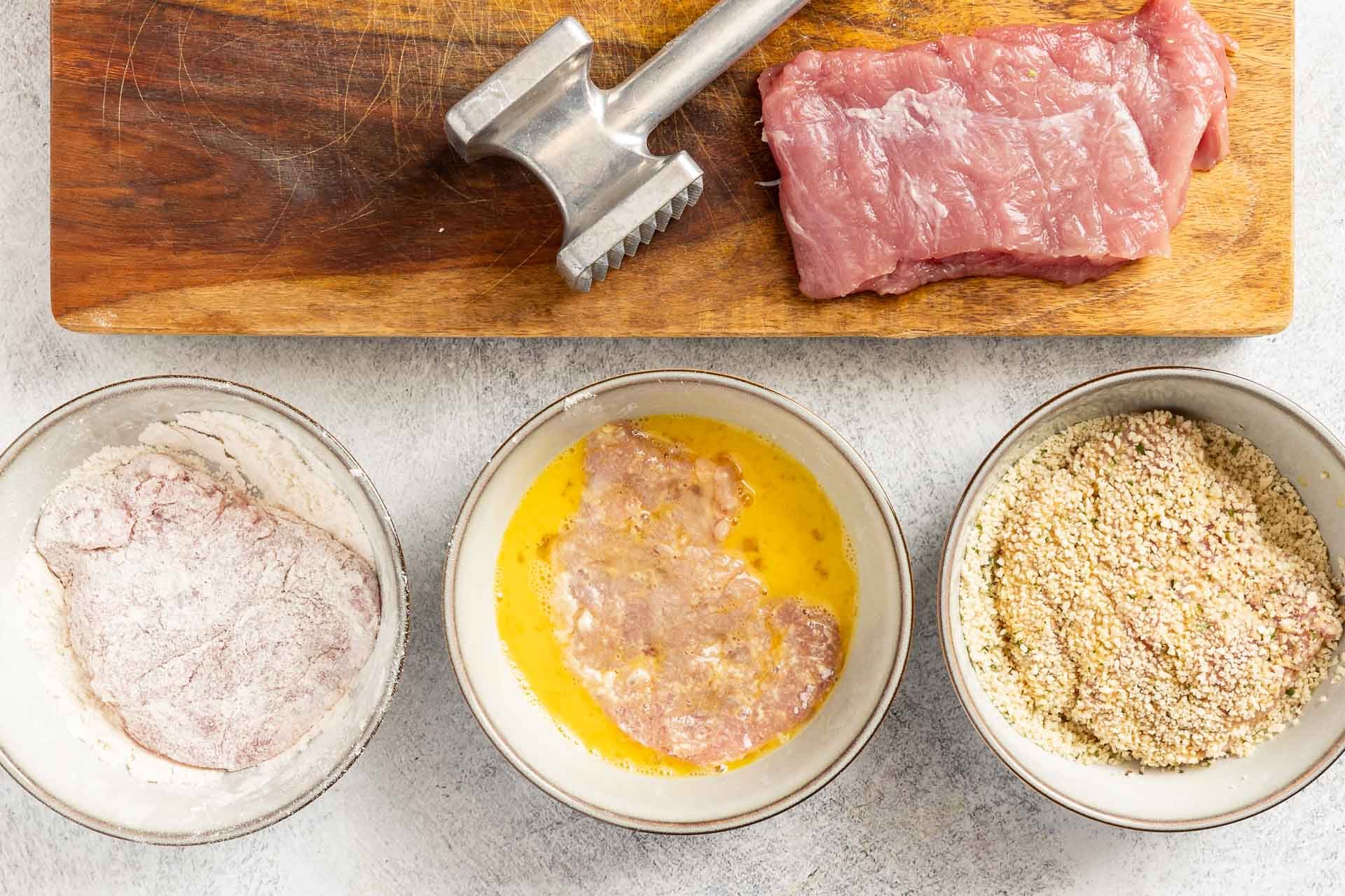 coating the pounded pork tenderloin in each station.