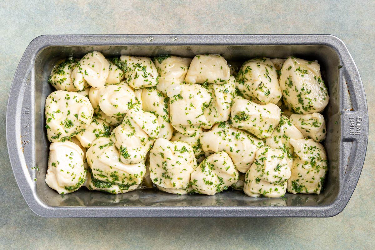 Taste of Home Pull Apart Garlic Bread photo of coated dough in a loaf pah.