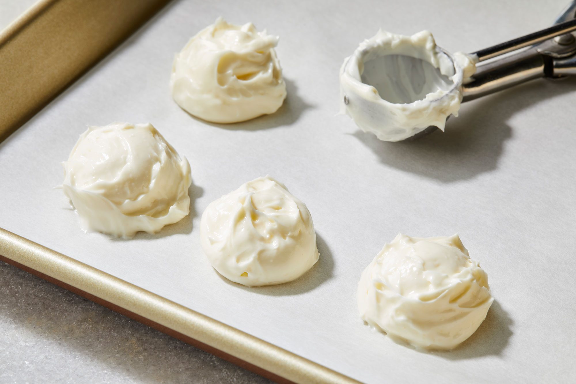 Tablespoon sized scoops on parchment lined baking sheet