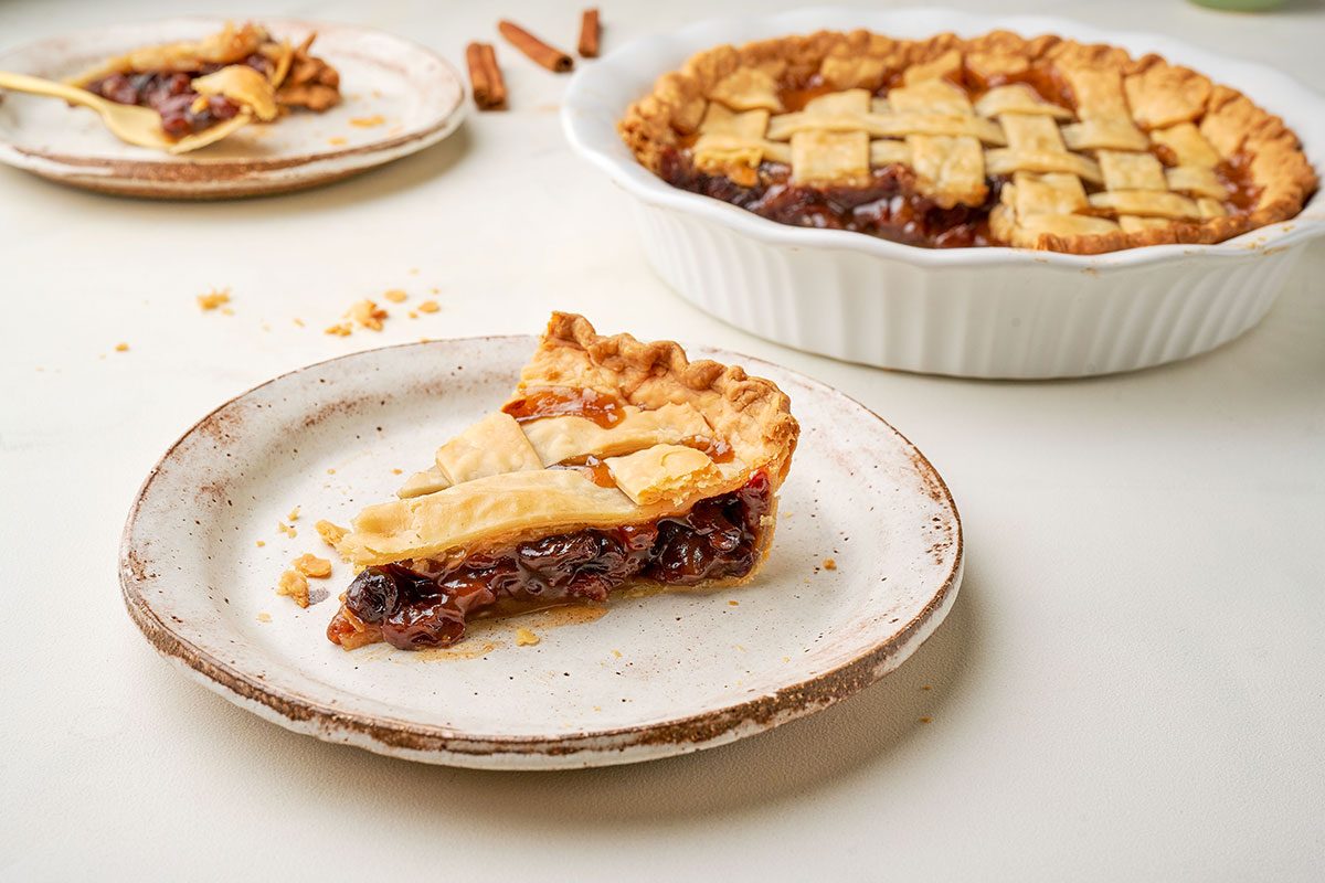 A close-up of Taste of Home's Raisin Pie, showcasing the detailed lattice crust and caramelized raisins peeking through.