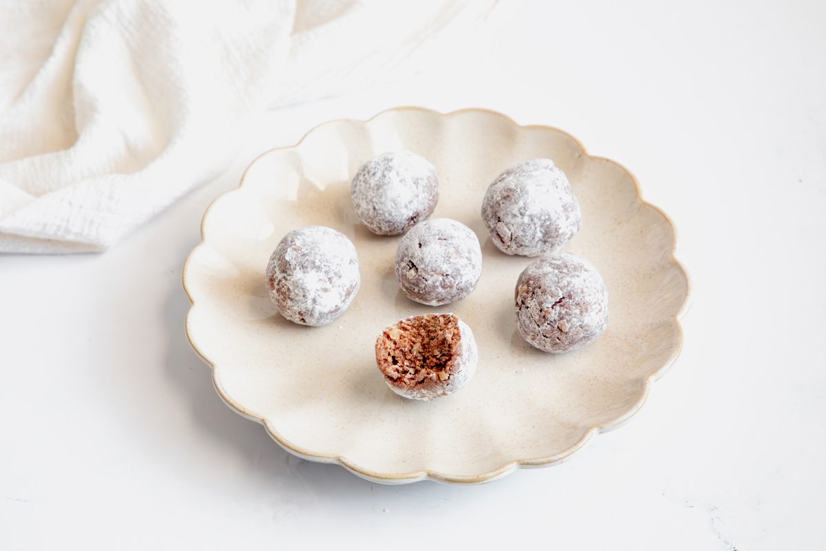 Close up shot for Taste of Home Rum Balls, with a bite out of one rum ball. 