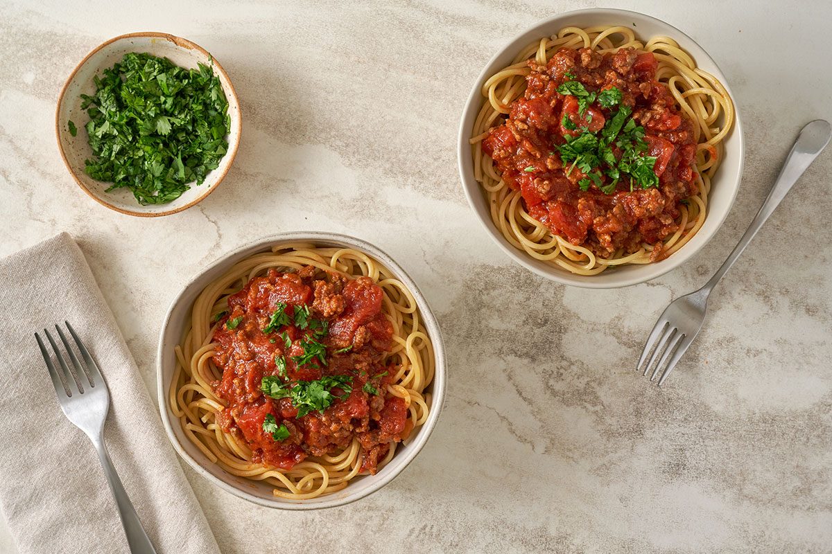 Taste of Home's Salsa Pasta recipe, featuring a bowl of spaghetti topped with a rich salsa-infused sauce and garnished with cilantro.