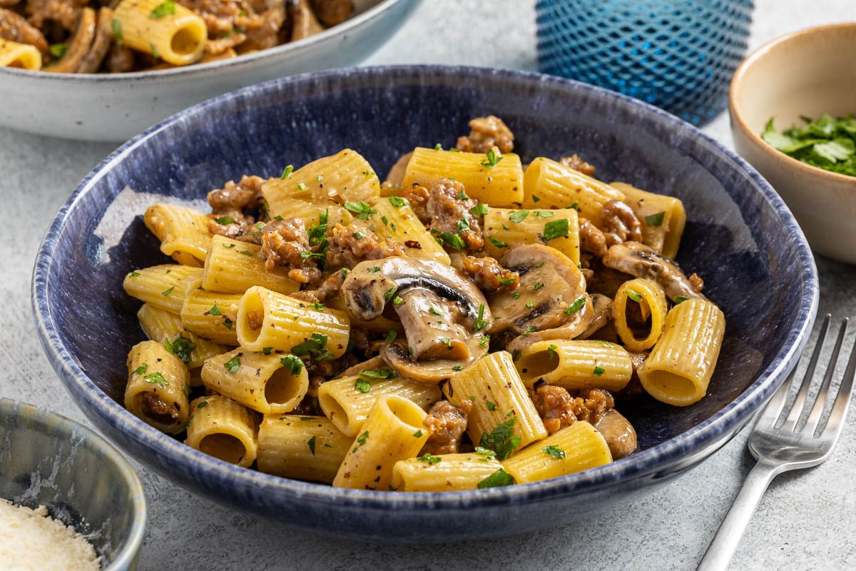 Taste of Home Sausage and Mushroom Pasta photo of the finished recipe served into pasta bowls.
