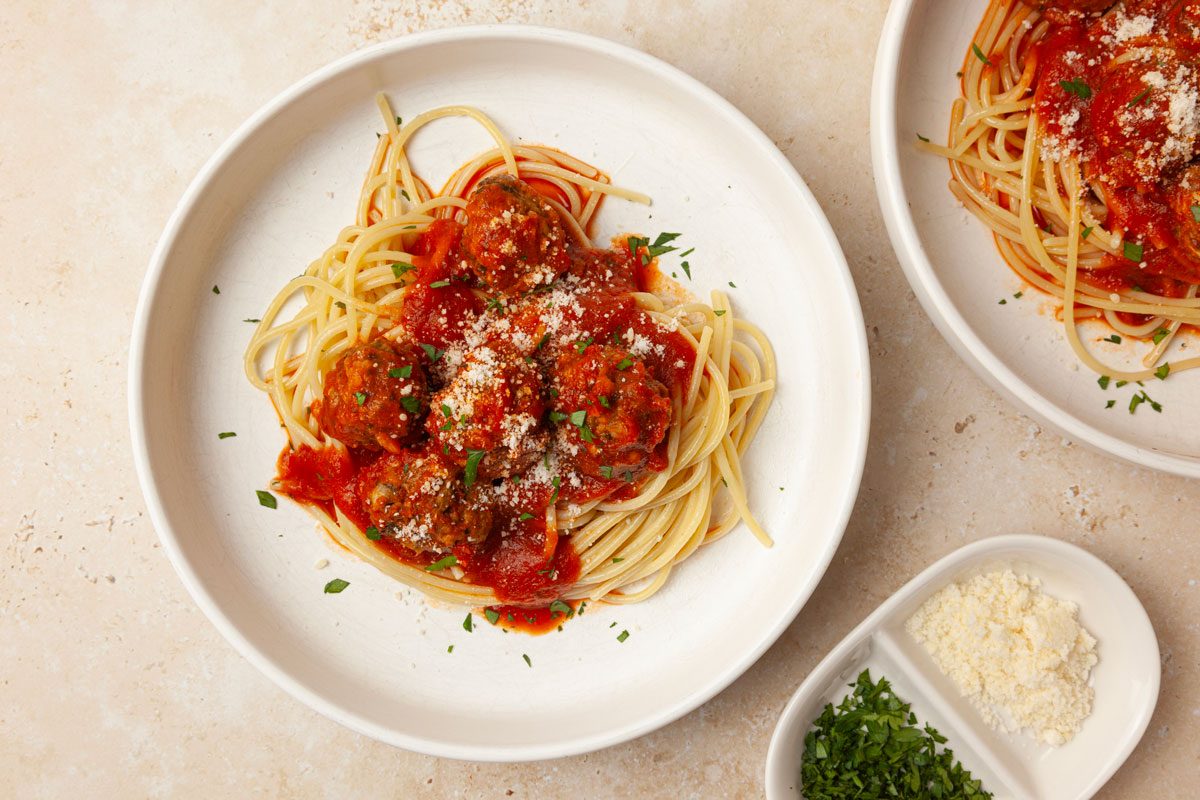 Single servings of Taste of Home Slow-Cooked Italian Meatballs garnished with parmesan cheese and parsley.