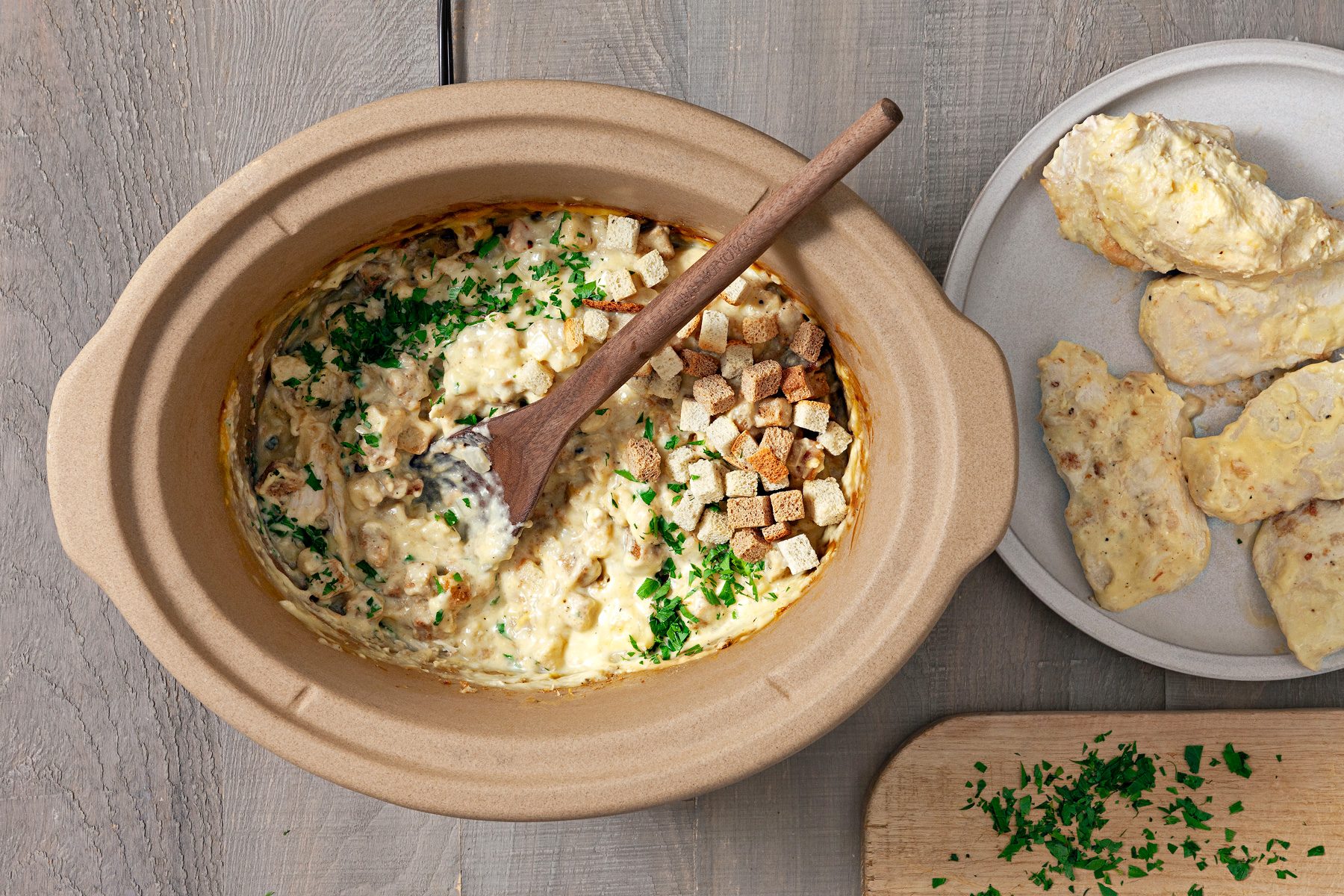 Chicken is removed, and additional parsley and black pepper are sprinkled in the cooker.
