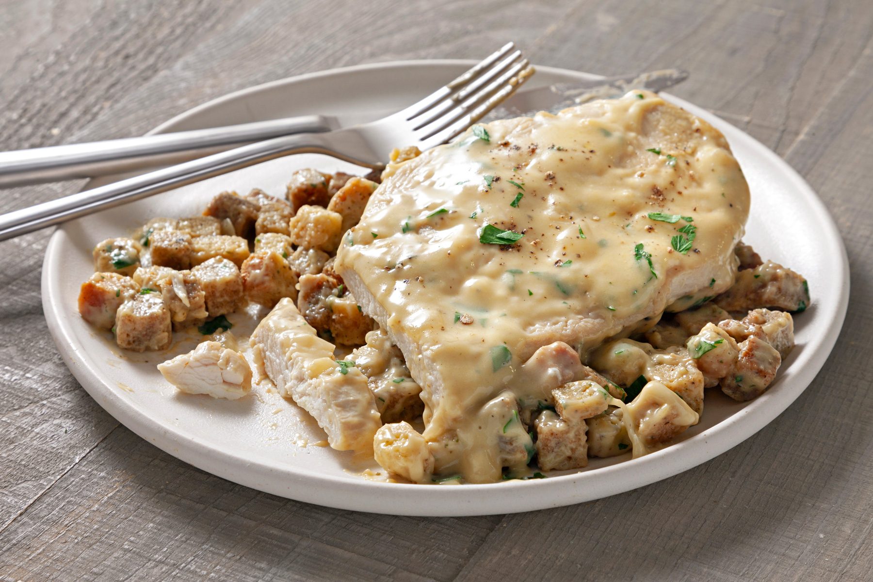 A 3/4 shot of slow cooker chicken stuffing served on a plate.
