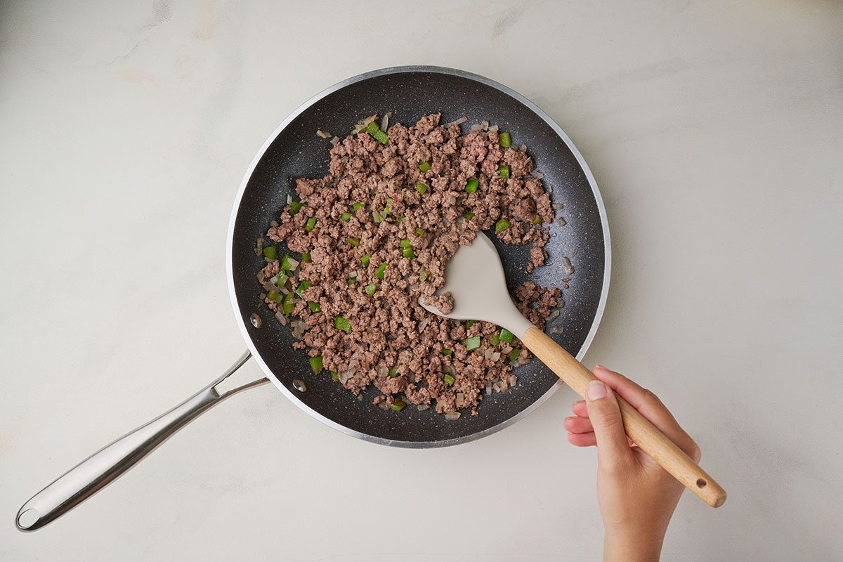 Cooking ground beef with green pepper and onion for Taste of Home's Spanish Noodles recipe