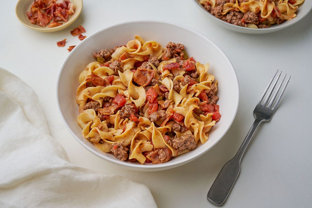 Close-up of Taste of Home's Spanish Noodles recipe, served with egg noodles, beef, and bacon