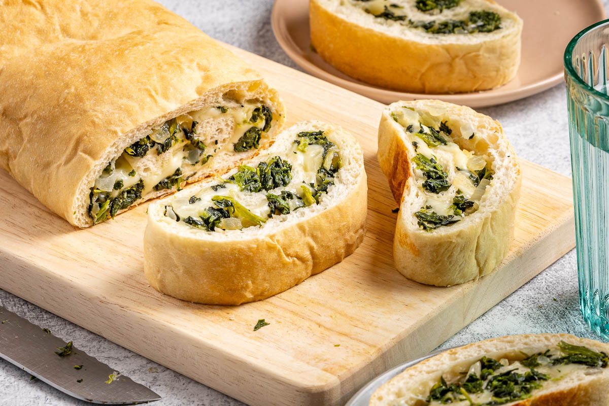 Taste of Home Spinach Bread photo of the finished recipe sliced and served on plates.