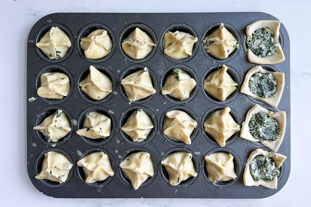 Unbaked Taste of Home Spinach Puffs in a mini muffin tin